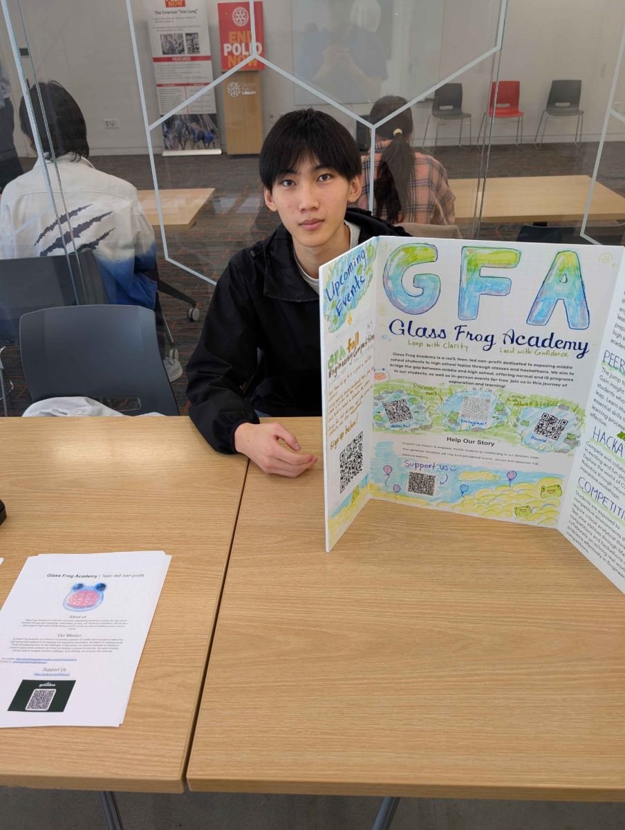 A GFA team member at our booth with a hand-drawn trifold board